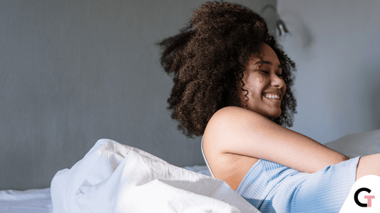 Girl with 4c curly hair on bed 