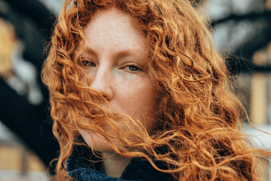 Woman with curly red hair in winter