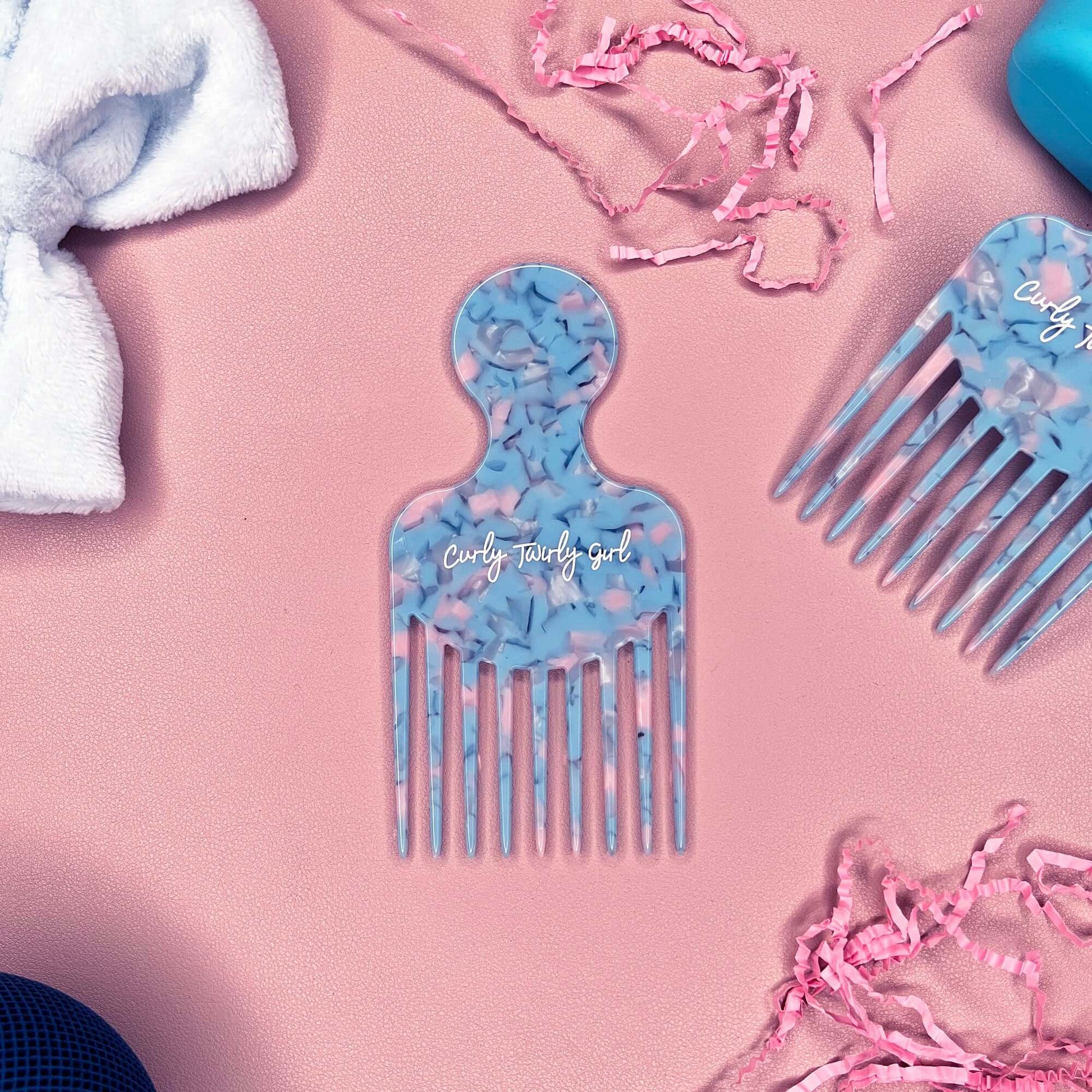 Blue afro hair comb on pink table