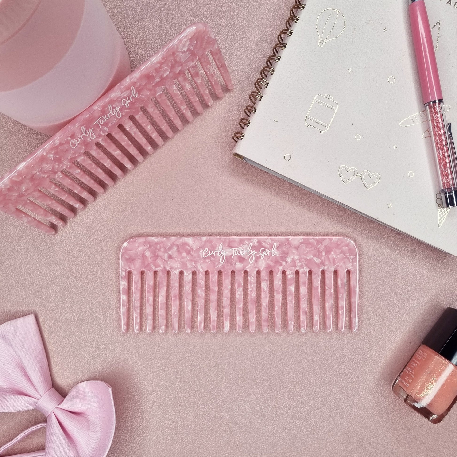 Pink wide tooth comb on a pink table